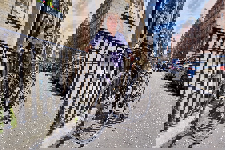 Clare pictured with her bike on a street in Glasgow city centre